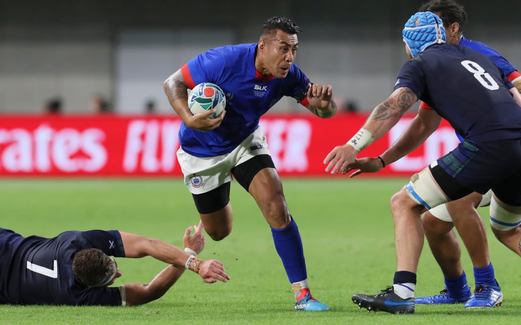 Samoa's Tusi Pisi takes on former Hurricanes teammate Blade Thompson.