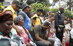Various family members of the 4 children that passed away in the surrounding area following heavy rains and floods grieve at the United Methodist Church of South Africa in Clermont, near Durban, on April 13, 2022.