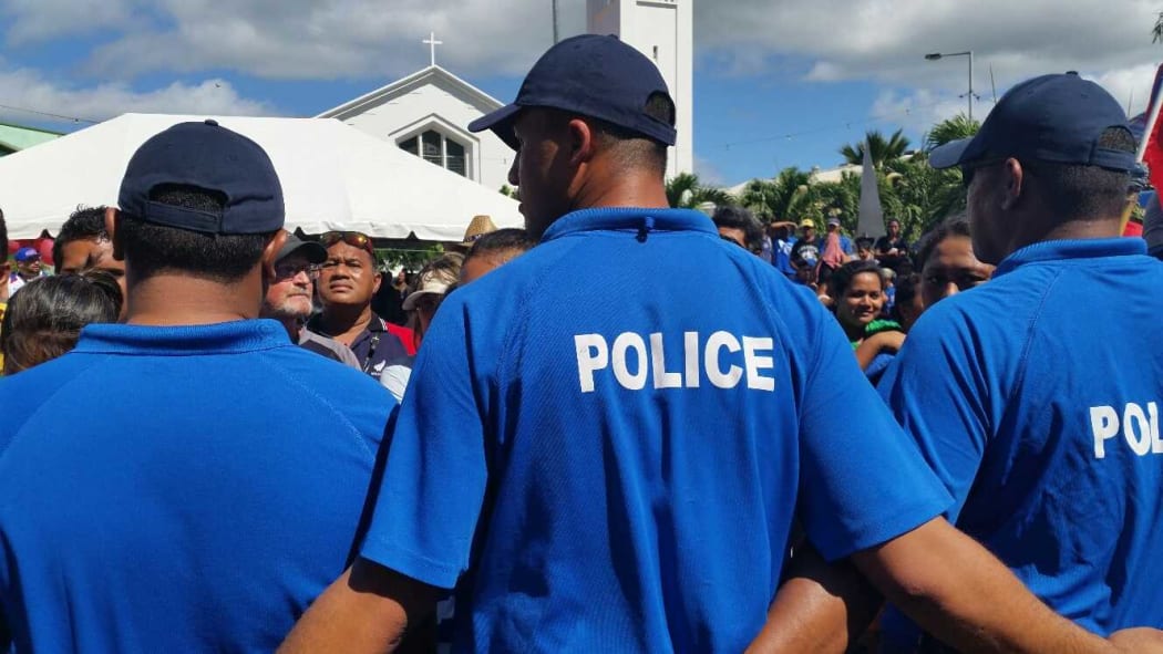 Police keep the crowds at bay during the speeches at today's parade.