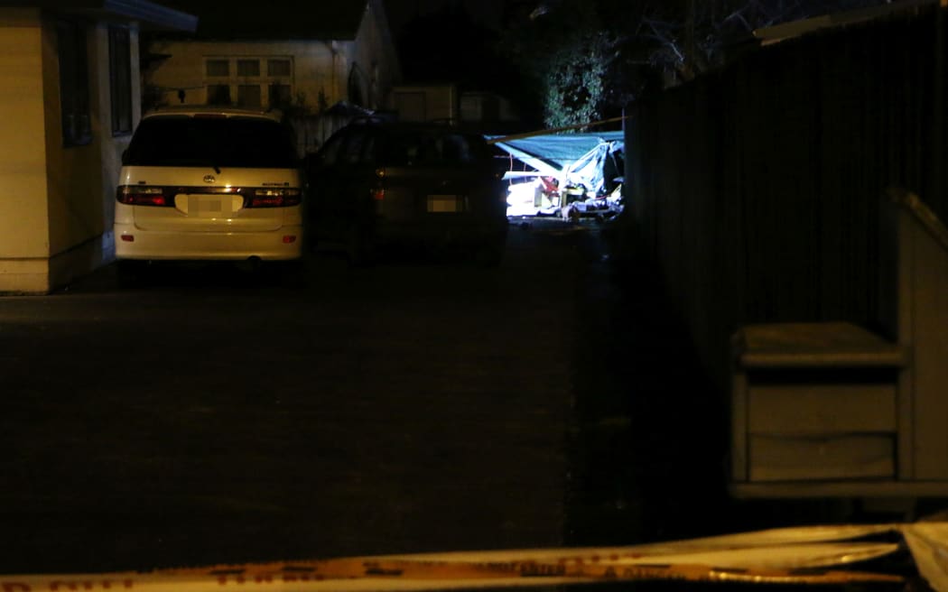 Debris from the explosion can be seen through the fence of a neighbouring property.