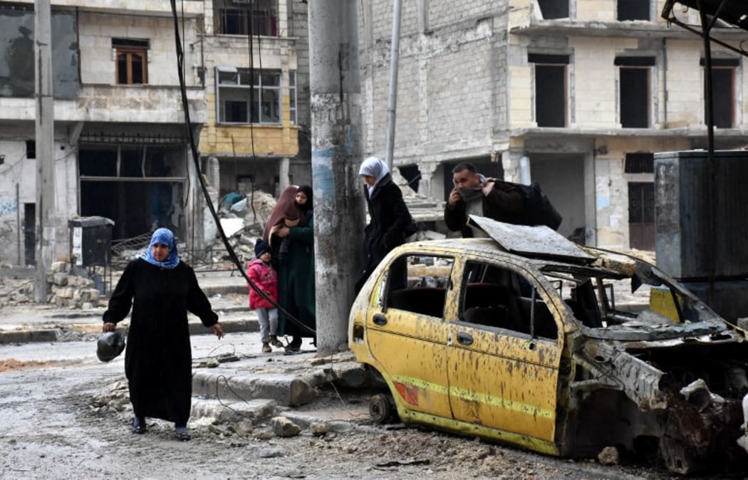 Syrian civilians from the al-Sukari neighbourhood flee on December 14 2016.