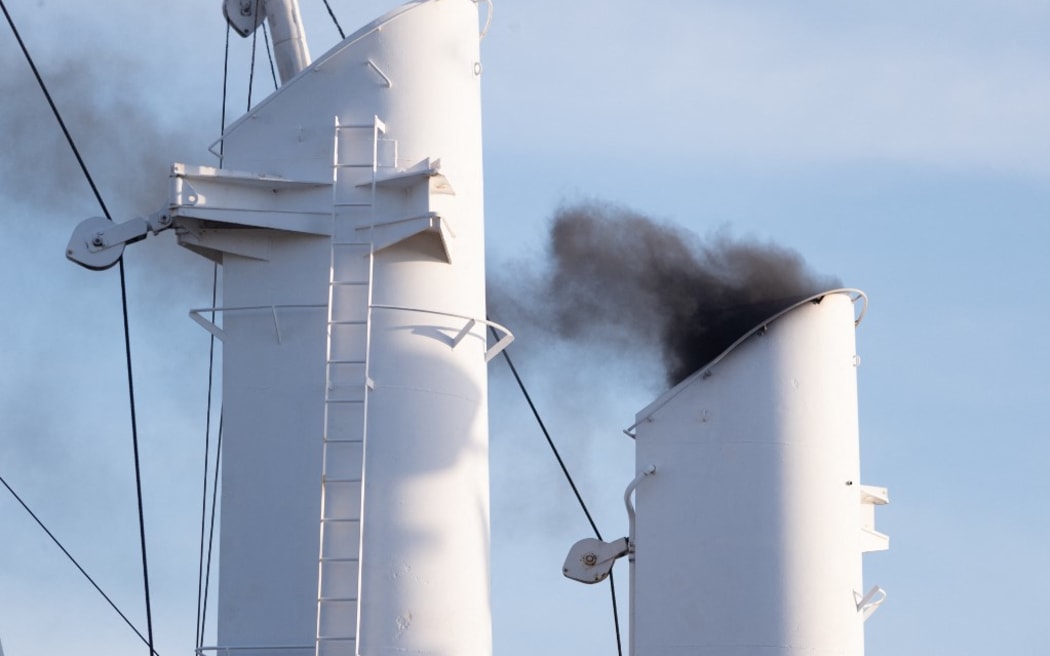 14 September 2019, Hamburg: The heavily smoking chimney of a ship at the Hamburg Cruise Days. In the course of the evening a parade with cruise ships and fireworks was held.