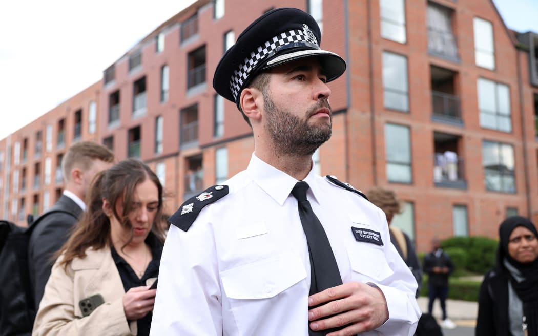 Metropolitan Police Chief Superintendent Stuart Bell reacts after making a statements to members of the media, from a crime scene in Hainault, east of London on April 30, 2024, where a 36-year-old man wielding a sword was arrested following an attack on members of the public and two police officers. A 13-year-old boy died on Tuesday after five people, including two police officers, were wounded by a man wielding a sword in east London, police said. "It's with great sadness that one of those injured in this incident, a 13-year-old boy, has died from their injuries," Chief Superintendent Stuart Bell, from the Metropolitan Police, told reporters. (Photo by Adrian DENNIS / AFP)