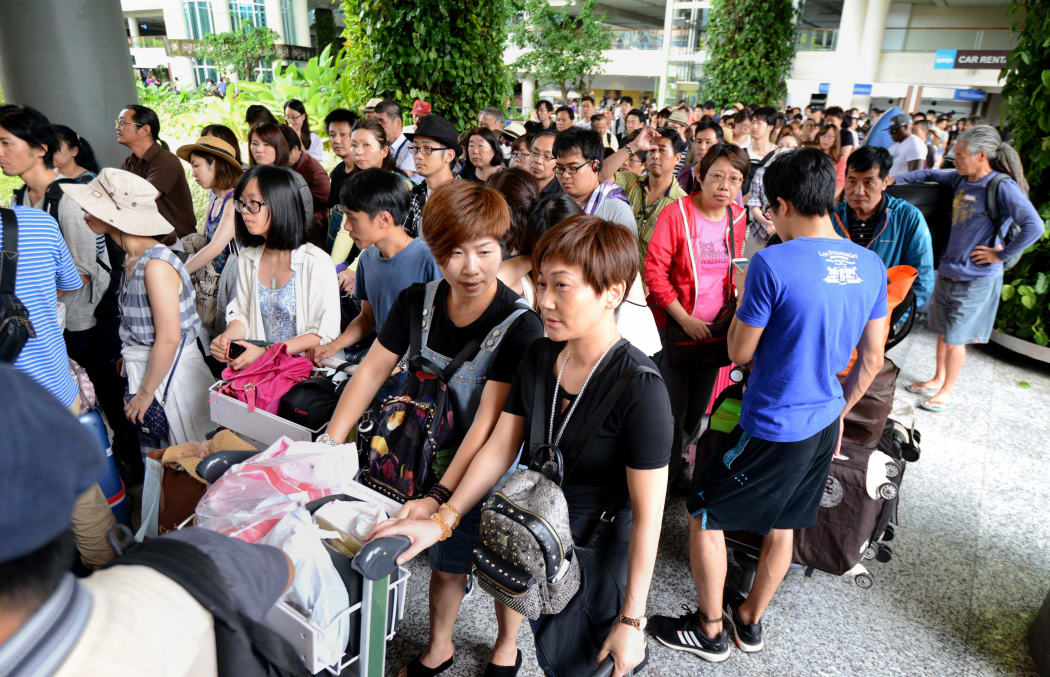 Passengers crowd the international terminal at Bali's Ngurah Rai Airport in Denpasar waiting for information of flight delays due to volcanic ash.