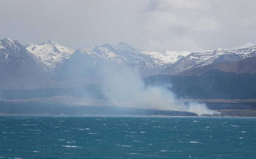 Daylight images of the Pukaki Downs fire from across Lake Pukaki.