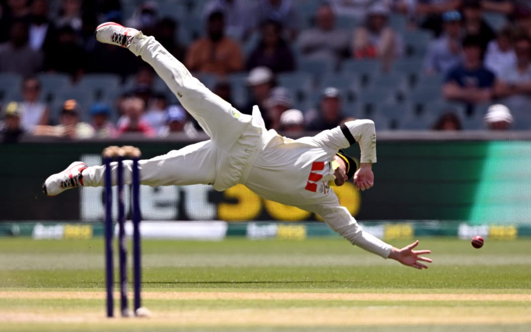 Australian fieldsman Josh Inglis dives to stop the ball on the final day of the third Ashes cricket Test match between Australia and England at the Adelaide Oval in Adelaide on December 21, 2025. (Photo by William WEST / AFP) / --IMAGE RESTRICTED TO EDITORIAL USE - STRICTLY NO COMMERCIAL USE--