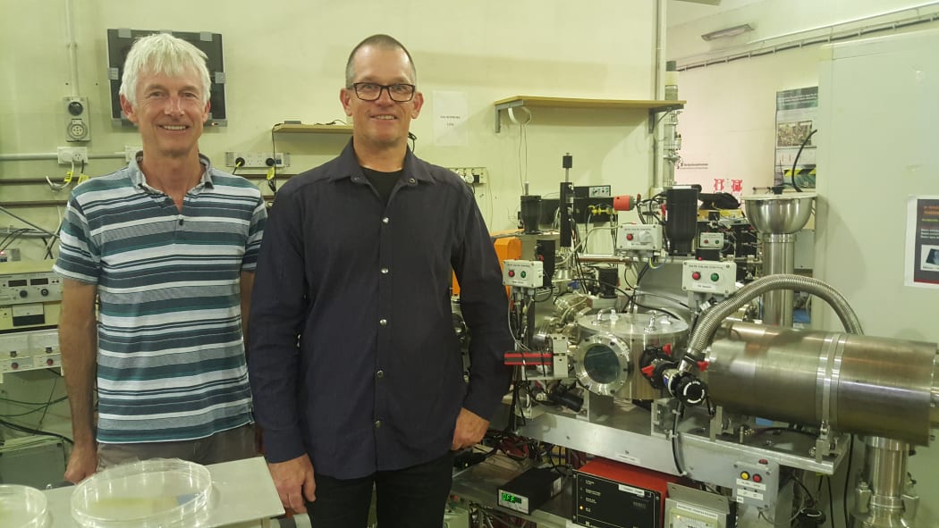 Physicist Bill Trompetter (left) and atmospheric chemist Perry Davy, from GNS Science, standing next to equipment used to measure levels of air pollution in New Zealand.