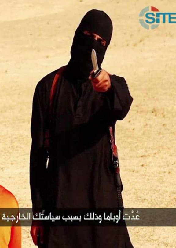 An Islamic State jihadist before he apparently beheads Steven Sotloff taken from a video released by the Islamic State.