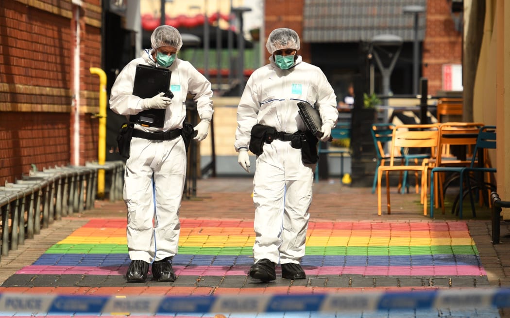 Police forensics officers gather evidence on Hurst Walk following a major stabbing incident in the centre of Birmingham, 6 September 2020.