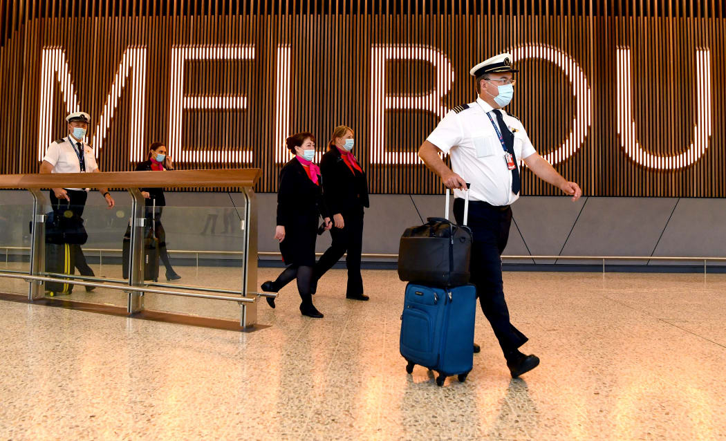 A Qantas flight crew arrive at Melbourne's Tullamarine Airport on November 29, 2021 as Australia records it's first cases of the Omicron variant of Covid-19. (Photo by William WEST / AFP)