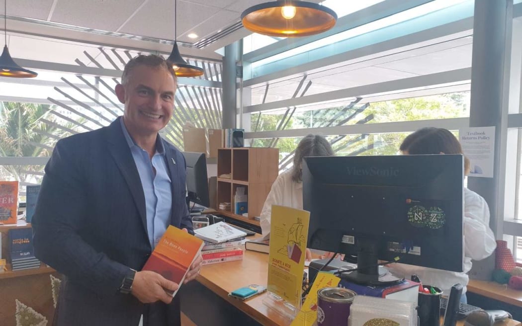 Minister for Small Business Stuart Nash buys a book at VicBooks in Wellington.
