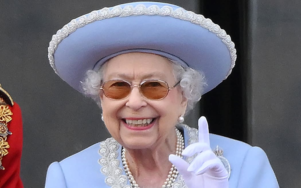 Britain's Queen Elizabeth II reacts as she watches a special flypast from Buckingham Palace balcony following the Queen's Birthday Parade, the Trooping the Colour, as part of Queen Elizabeth II's platinum jubilee celebrations, in London on June 2, 2022. - Huge crowds converged on central London in bright sunshine on Thursday for the start of four days of public events to mark Queen Elizabeth II's historic Platinum Jubilee, in what could be the last major public event of her long reign. (Photo by Daniel LEAL / AFP)