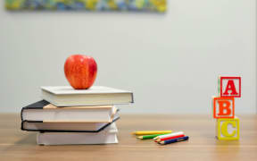 Apple, books, pencils and building blocks.