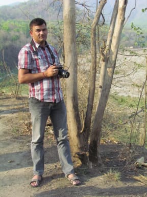 Dr Bargali stands with camera outside