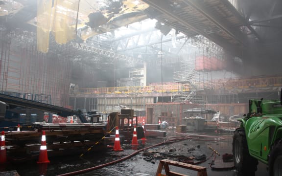 Plenary Theatre main floor, at the back of the theatre you can see the raked seating. Above you can see part of the collapsed roof (which includes gibing and other materials) but you can also see that the physical roof structure is still intact.