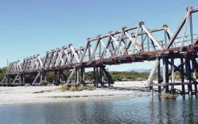 Closure of ancient rail bridge wrecks cycle tour business for Ross - but council can't afford to rebuild it. Mayor says govt should let councils levy a toll on cyclists to fund capital works.