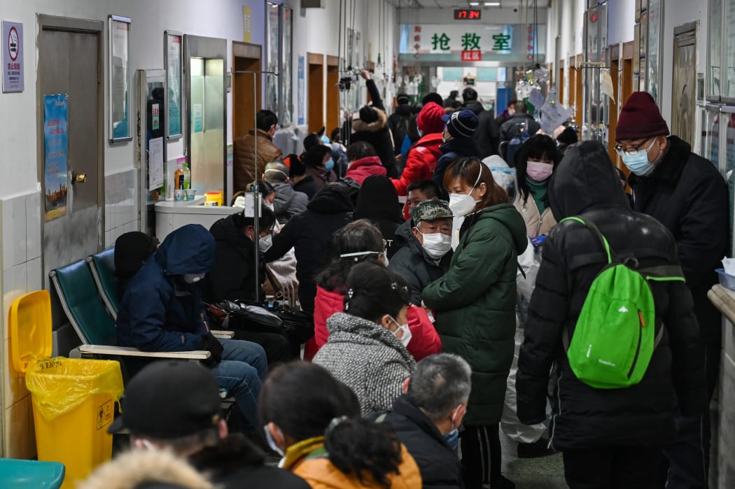 People wearing face masks wait for medical attention at Wuhan Red Cross Hospital in Wuhan on January 25, 2020.