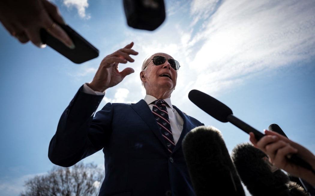 US President Joe Biden talking to media on the South Lawn of the White House before boarding Marine One on 28 March, 2023 in Washington, DC.