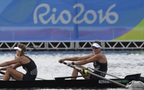 New Zealand's Genevieve Behrent and New Zealand's Rebecca Scown (L) row during the Women's Pair semifinal rowing competition at the Lagoa stadium during the Rio 2016 Olympic Games in Rio de Janeiro on August 11, 2016.
