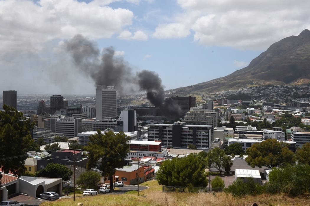 Smoke rises up from the Parliament building in Cape Town.
