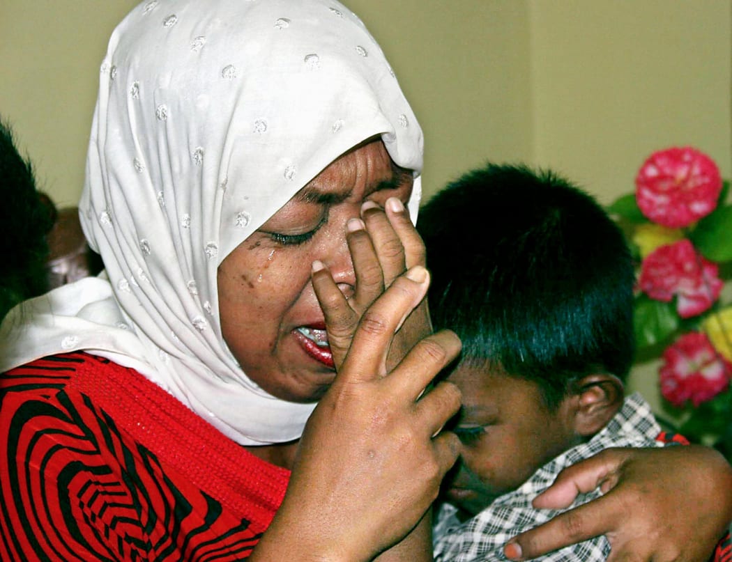 Indonesian Hayatun Nafis hugs her 10-year-old son Muhammad Nurwansyah after they were reunited in Banda Aceh, 15 February 2005, since the deadly 26 December 2004 tsunami.