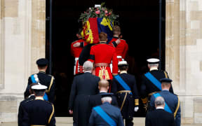 The Bearer Party take the coffin of Queen Elizabeth II, from the State Hearse, into St George's Chapel inside Windsor Castle on September 20, 2022.
