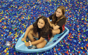 Elliot Chadwick and Emma Smith of Stratford Primary School afloat on a sea of lids