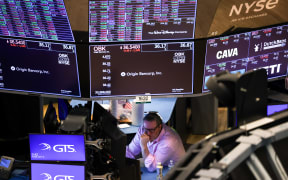 A trader works on the floor of the New York Stock Exchange 10 March 2025.