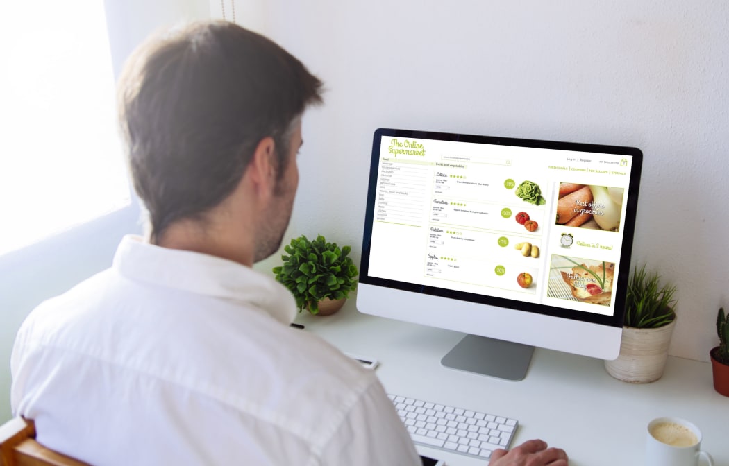 Man shopping groceries online on computer
