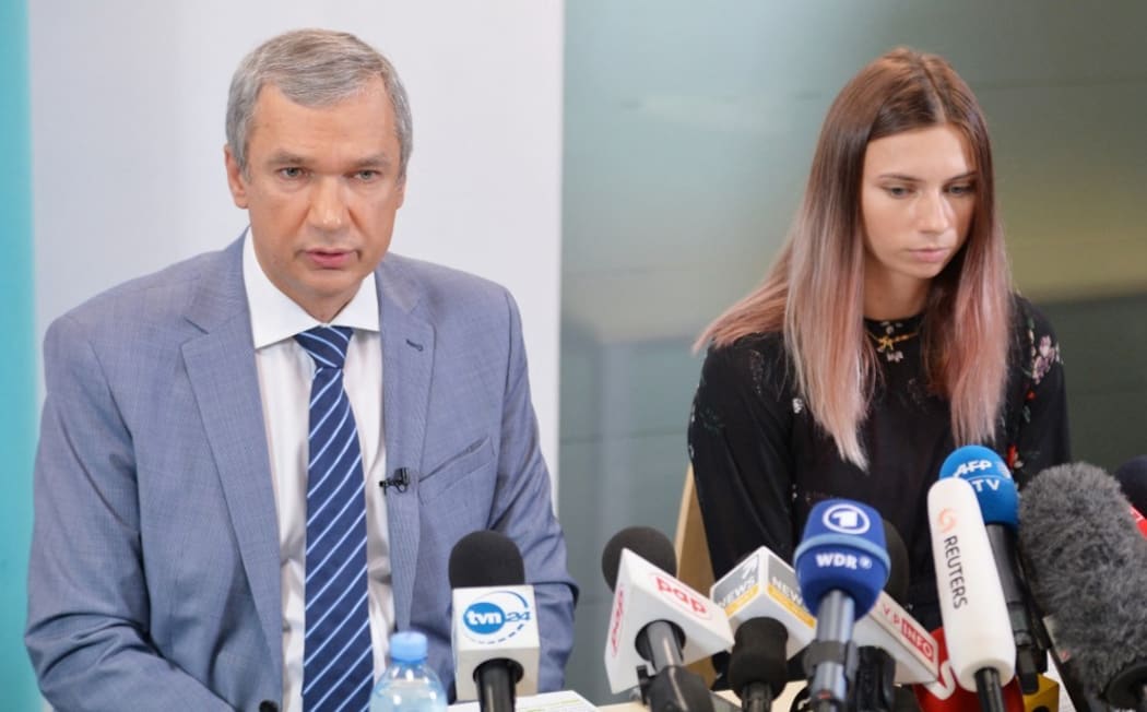 Belarusian Olympic athlete Krystsina Tsimanouskaya and Belarusian opposition politician Pavel Latushko attend a news conference in Warsaw, Poland. T