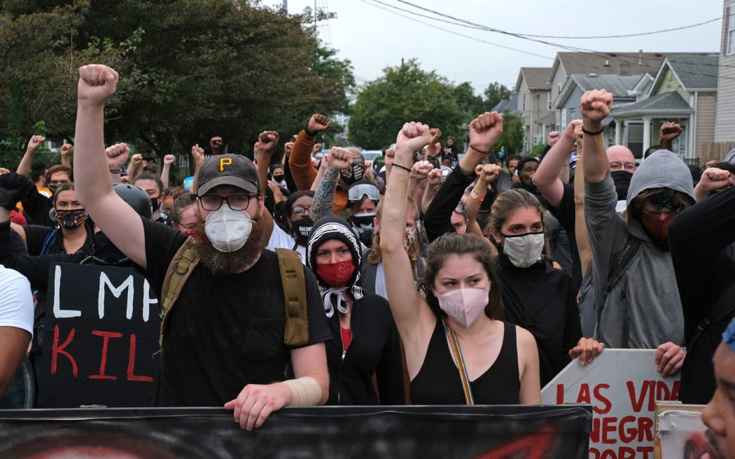 Protesters march in Louisville, Kentucky, on September 23, 2020, after a judge announced the charges brought by a grand jury against Detective Brett Hankison, one of three police officers involved in the fatal shooting of Breonna Taylor in March.