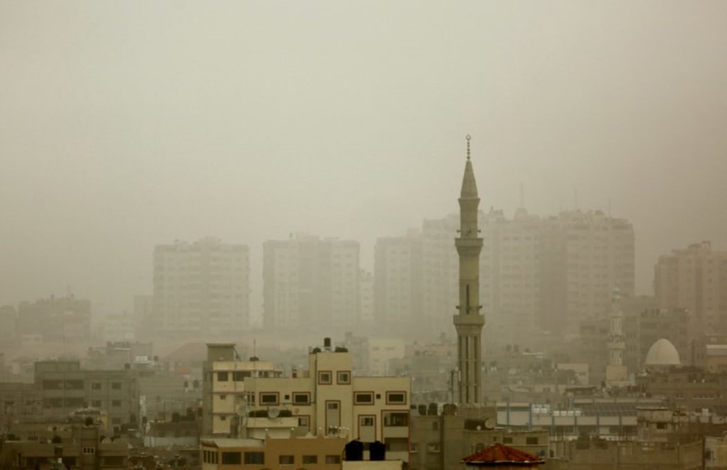 Gaza City's skyline is seen engulfed in dust as a storm hits the region.