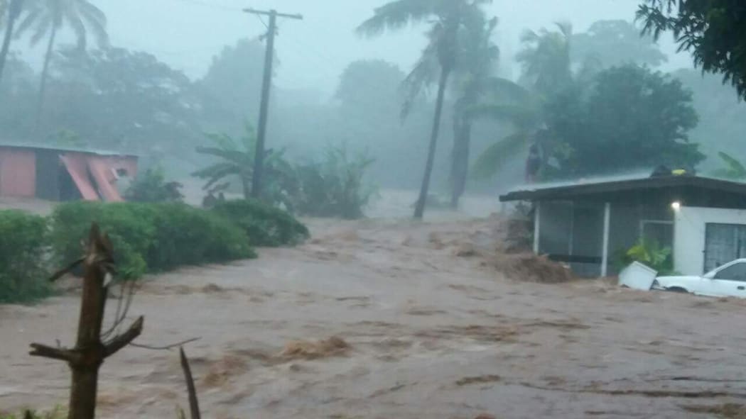 Homes engulfed by floodwaters during a cyclone in Fiji.