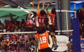 Marshall Islands players get set to block a spike by Guam at the 9th Micronesian Games.
