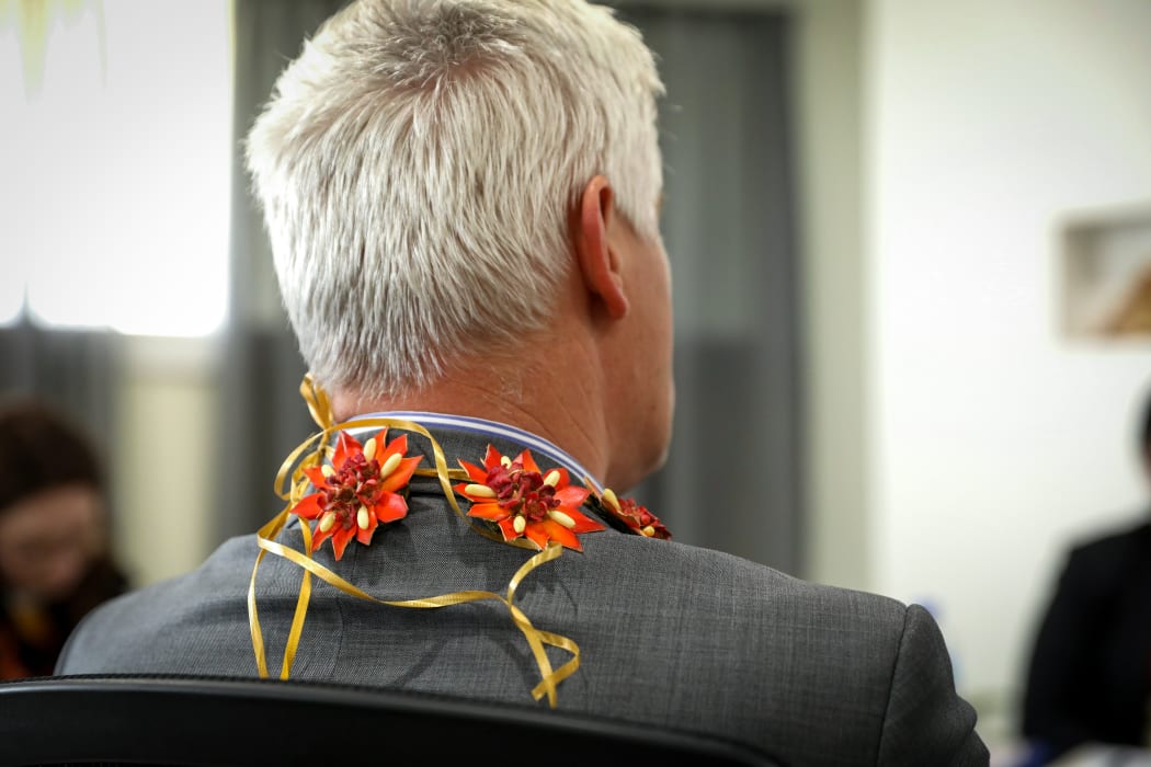 National MP Tim MacIndoe in Tonga wearing a kahoa (lei) around his neck made with Tonga's national flower, heilala.