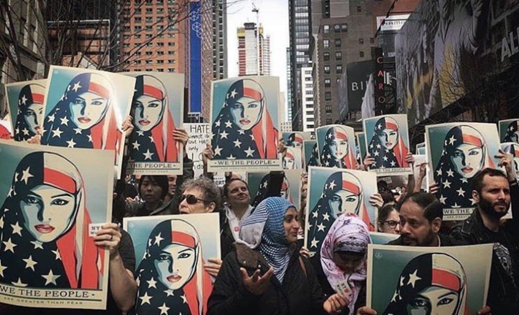 People with We The People posters marching on Inauguration Day in the United States last year.