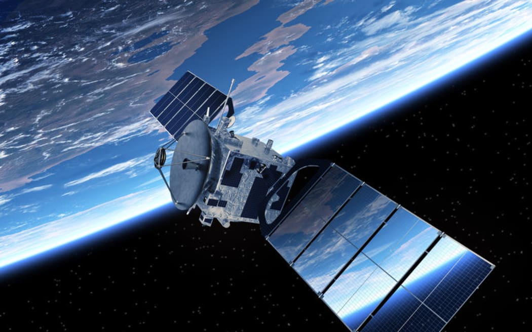 A communication satellite orbiting the earth.