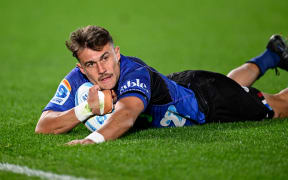 Cole Forbes of the Blues scores against the Highlanders in the Gordon Hunter Memorial Trophy match and round 13 of the Super Rugby Pacific competition at Eden Park.