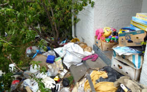 Items can be seen filling the yards of a property.