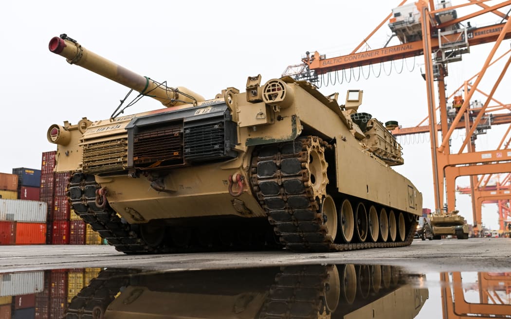 In this file photo taken on 3 December, 2022, an M1A2 Abrams battle tank of the US army, that will be used for military exercises by the 2nd Armored Brigade Combat Team, is unloaded at the Baltic Container Terminal in Gdynia, Poland.