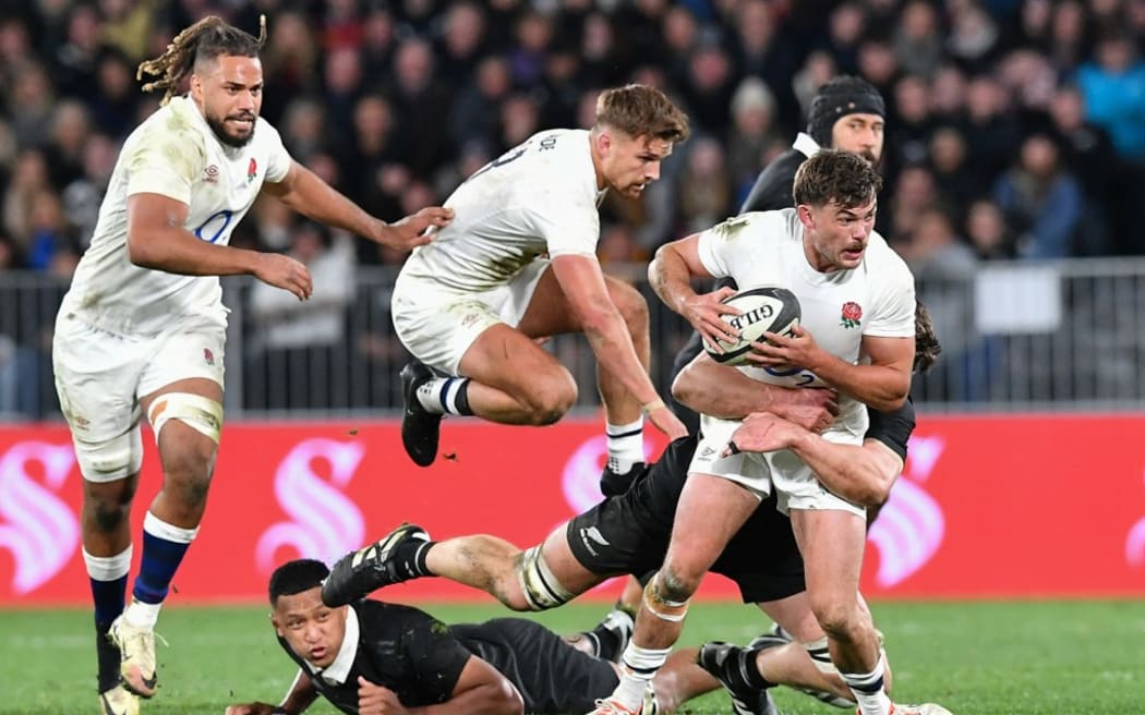 England's George Furbank (R) charges forward during the rugby union Test match between the All Blacks and England at Forsyth Barr Stadium in Dunedin on July 6, 2024.