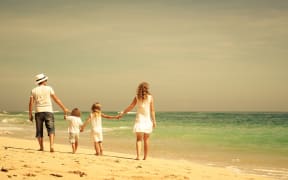 Family walking at the beach.