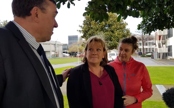 Inspector Scott Miller, Lois Tolley's aunt Yvonne Tolley, and a support person outside of court.