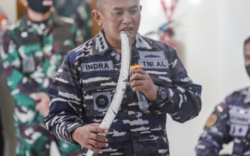 Indonesian Navy personnel shows one of debris from missing Indonesian navy submarine KRI Nanggala 402