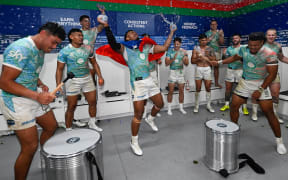 Warriors players celebrate in the dressing after beating Brisbane Broncos by golden point.