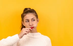 young woman brushing her teeth