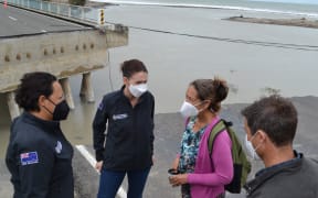 From left: Emergency Management minister and East Coast MP Kiri Allan, Prime Minister Jacinda Ardern, Te Kura Kaupapa Māori o Nga Taonga Tuturu ki Tokomaru tumuaki Herena Paranihi and the Prime Minister's fiance Clarke Gayford speak about the flood damage.