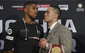 Britain's Anthony Joshua (L) and New Zealand's Joseph Parker (R) face off posing during a press conference in London.