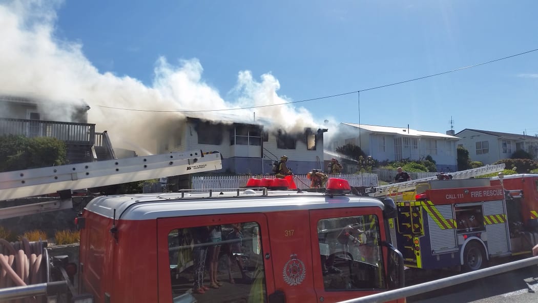 Smoke pours from a house on Te Pene Avenue, Titahi Bay.