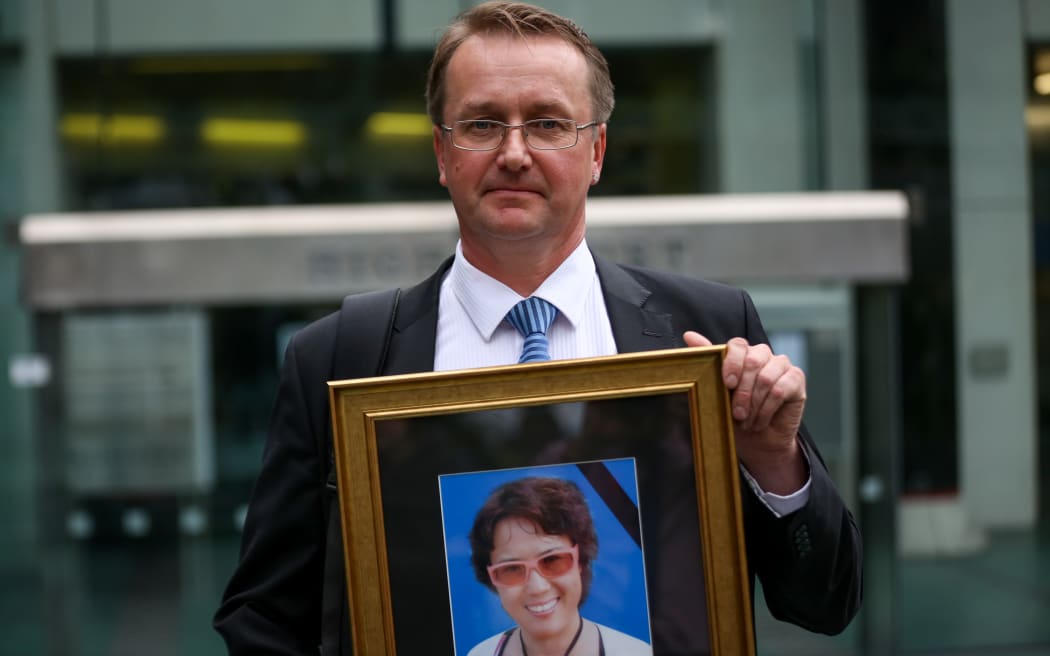 Mei Fan's former boyfriend, Tani Hoyhtya holding a photo of Ms Fan that he's giving to the New Zealand police for their work.